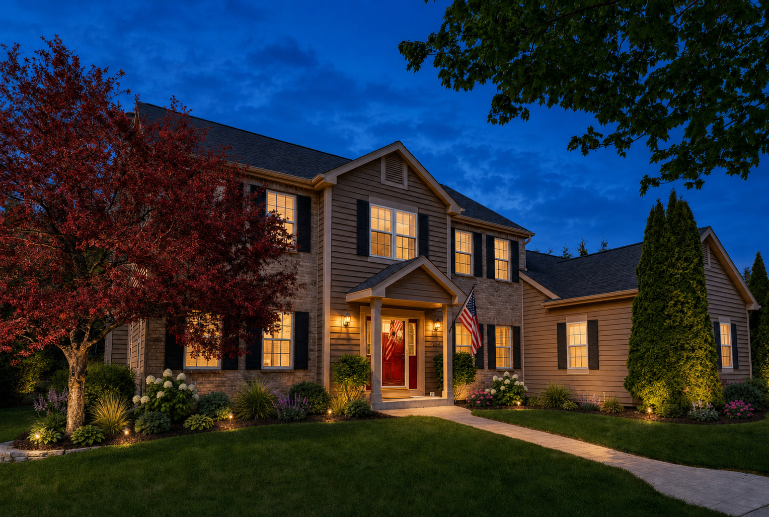Landscape lighting concept on a traditional Midwest home at dusk